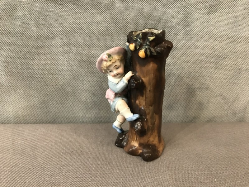 A little girl climbing to the trunk of a 19th-century porcelain tree