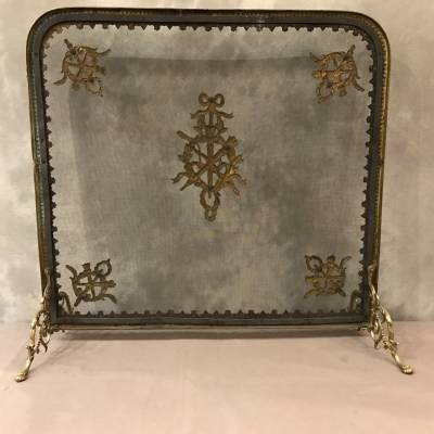 Pare fire screen of antique fireplace in vintage bronze