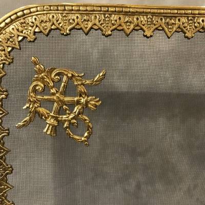 Pare fire screen of antique fireplace in vintage bronze