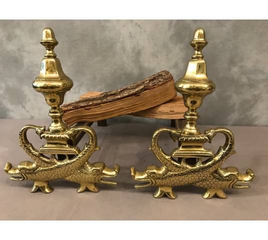 Pair of brass chenets to the 19th-century dolphins