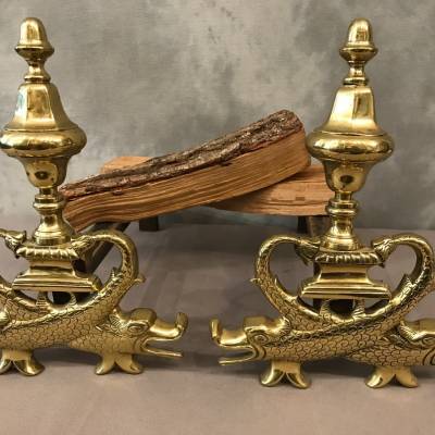 Pair of brass chenets to the 19th-century dolphins