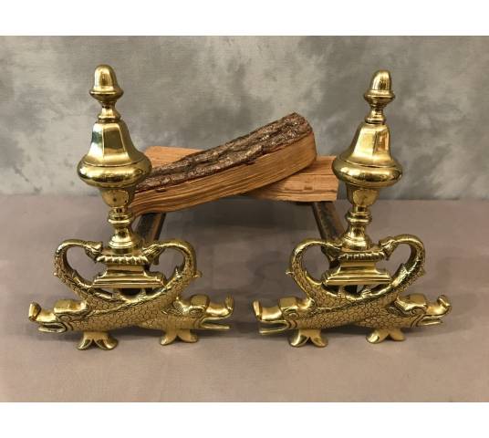 Pair of brass chenets to the 19th-century dolphins