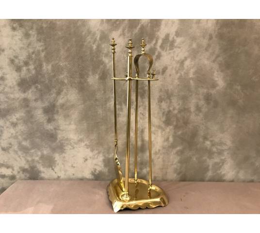 Antique fireplace set in polished brass and varnish from the 19th-century.