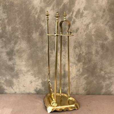 Antique fireplace set in polished brass and varnish from the 19th-century.