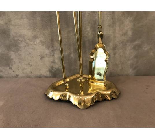 Antique fireplace set in polished brass and varnish from the 19th-century.