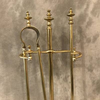 Antique fireplace set in polished brass and varnish from the 19th-century.