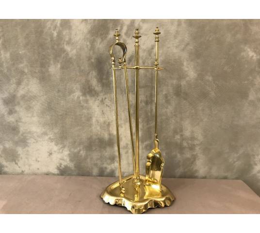 Antique fireplace set in polished brass and varnish from the 19th-century.