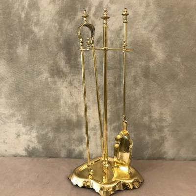 Antique fireplace set in polished brass and varnish from the 19th-century.