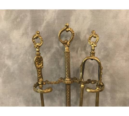 Servant of a fireplace in vintage brass 19 th of the Louis XV style