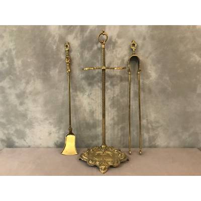 Servant of a fireplace in vintage brass 19 th of the Louis XV style