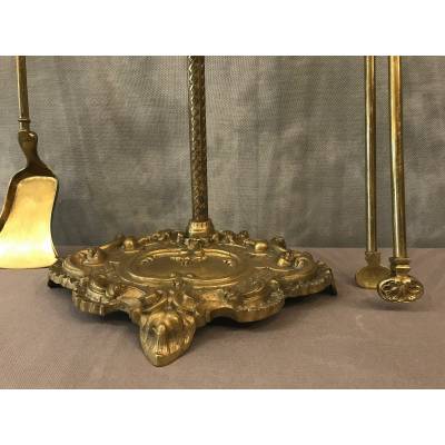 Servant of a fireplace in vintage brass 19 th of the Louis XV style