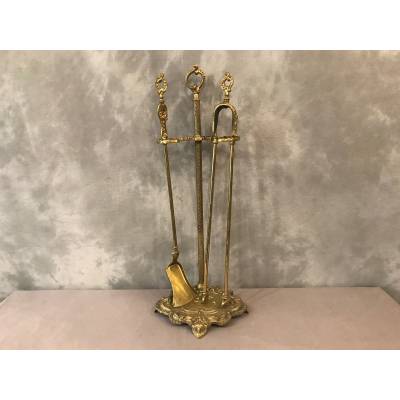 Servant of a fireplace in vintage brass 19 th of the Louis XV style